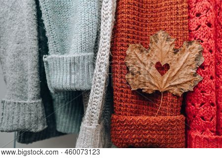 Autumn Concept. Fall Maple Leaf In Heart Shape On Cozy Warm Sweater. Knitted Woolen And Mohair Sweat