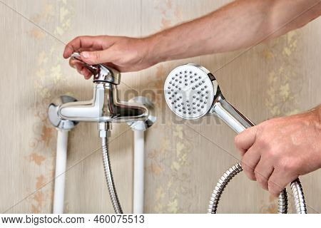 Plumber Connected Showerhead With Flexible Hose To Single Lever Faucet In Bathroom.