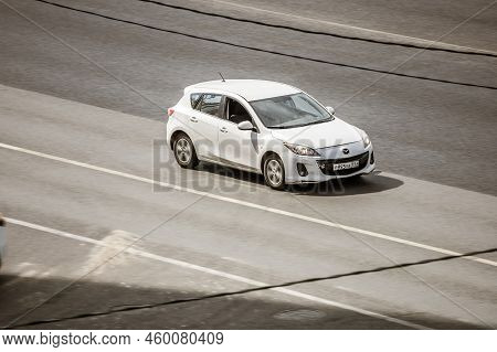 White Mazda 3 Car Moving On The Street. Moscow, Russia - August 2022