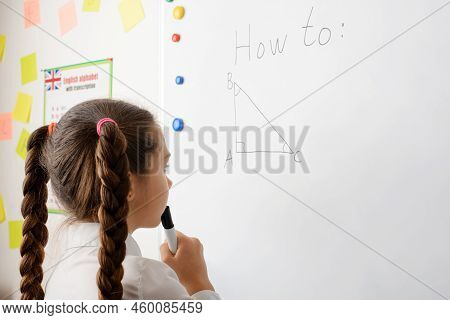 Caucasian Secondary School Learner Doing Geometrical Task On The Board, Thinking About The Pythagore