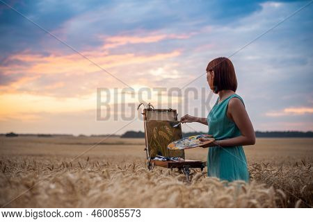 Artist At Work. Beautiful Evening In The Field Of Ripe Rye And Inspired Artist Making Final Touches 
