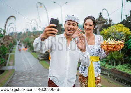 Balines Couple Make A Video Call During Holy Day Of Galungan