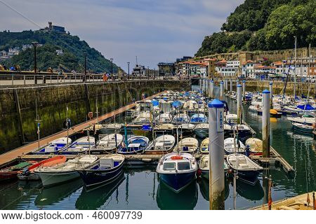 San Sebastian, Spain - June 26 2021: View Of Colorful Fishing Boats On La Concha Bay With Monte Urgu