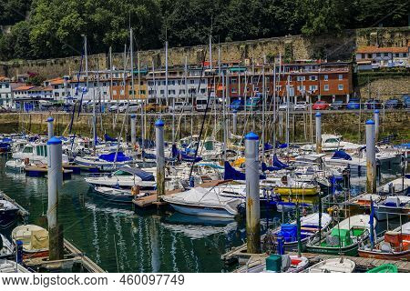 San Sebastian, Spain - June 26 2021: View Of Colorful Fishing Boats On La Concha Bay With Monte Urgu