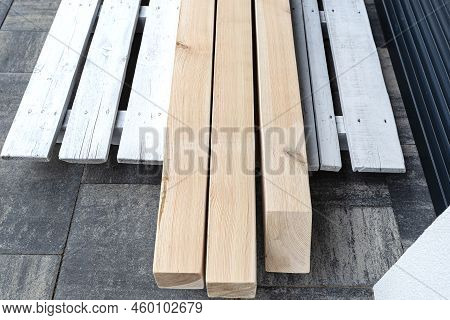 Raw Planed Pine Wooden Beams, Dimensions 100x100mm, Lying Next To Each Other.