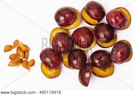 Pitted Plums For Making Jam Or Preserves On A White Background Top View