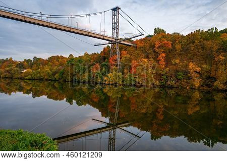 Autumn Scenery With Colorful Trees Reflected In The Water. Pedestrian Bridge Across Teteriv River, Z