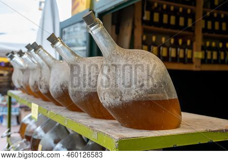 Big Bottles With White Wine Austrian Vinegar Made From Local Grapes On Market In Vienna, Austria
