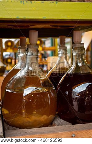 Big Bottles With White And Red Wine Austrian Vinegar Made From Local Grapes On Market In Vienna, Aus