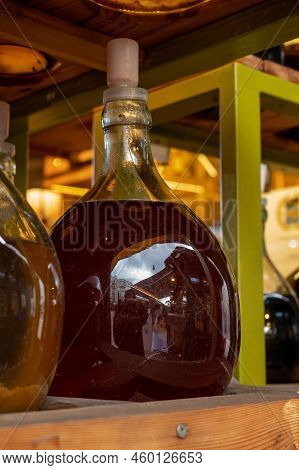 Big Bottles With White And Red Wine Austrian Vinegar Made From Local Grapes On Market In Vienna, Aus