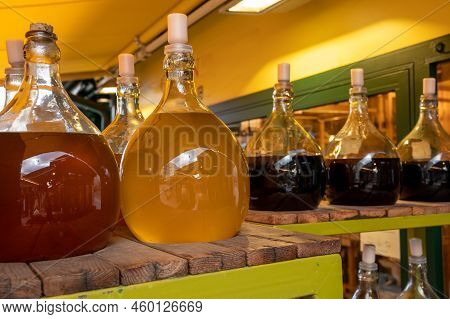 Big Bottles With White And Red Wine Austrian Vinegar Made From Local Grapes On Market In Vienna, Aus