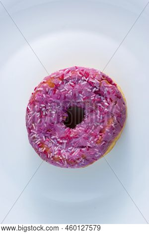 Pink Doughnut With Powder On A White Plate