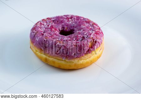 Pink Doughnut With Powder On A White Plate