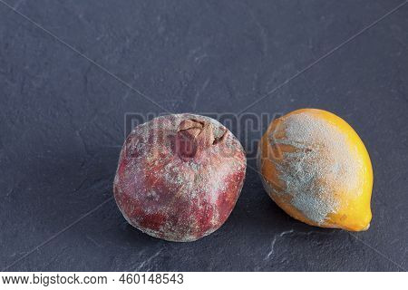 Improper Food Storage. Expired Spoiled Fruits. Moldy Lemon. Pomegranate With Mold. Dark Background. 