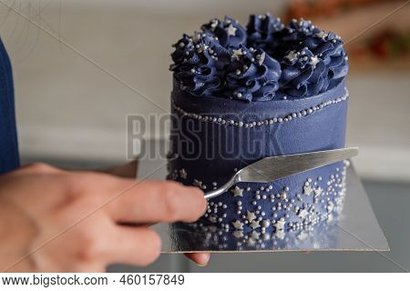 Leveling The Cream On The Sponge Cake With Spatula. Confectioner Is Leveling Cake With Spatula And C