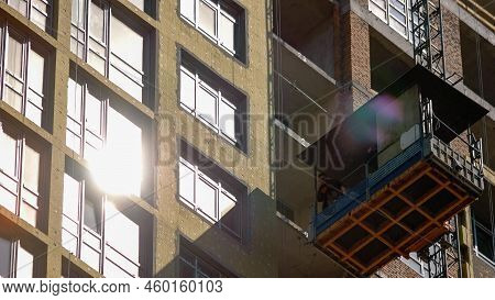 Constructruction Workers On The Elevator Are Moving Down. High Speed Motion.