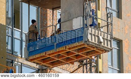 Kyiv, Ukraine - 24.04.2019: Construction Workers Move Down On The Elevator Lift.