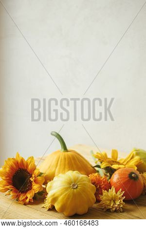 Stylish Autumn Composition On Rustic Background. Colorful Autumn Flowers, Pumpkins, Pattypan Squashe