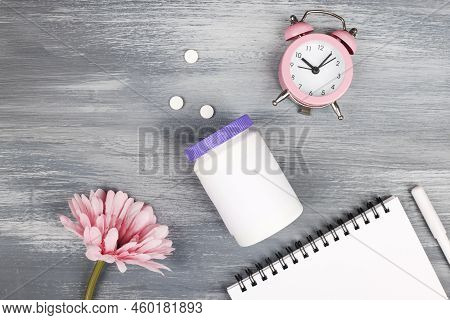 Women Health, Middle Age And Menopause Concept. Health Care Style. Copy Space. White Plastic Bottle 