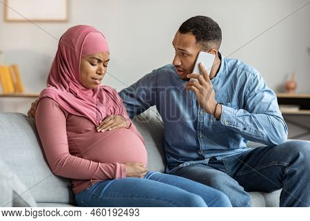 Worried Man Calling Doctor While His Pregnant Muslim Wife Suffering Prenatal Contractions