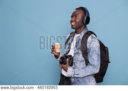 Smiling Young Man With Professional Camera And Backpack Going On Holiday Trip. Photography Enthusias