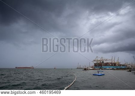 Koper, Slovenia - September 17, 2021: Young Kid Swimming In Front Of A Panorama Of Port Of Koper, Wi