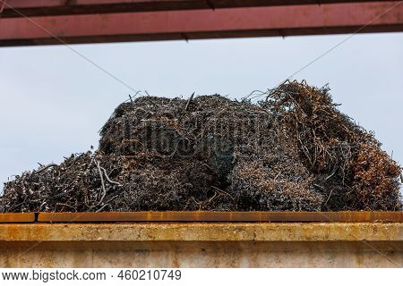 Pile Of Metal Swarf On Blue Sky Background, Close-up.