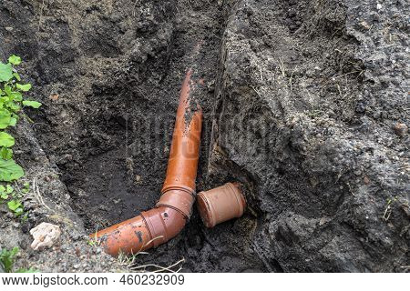 An Orange Plastic Pipe From A Septic Tank With A Diameter Of 160 Mm Lying In A Ditch.