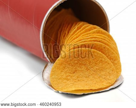 Stacked Crisps Falling Out From Red Cardboard Tube, Paprika Flavoured Potato Chips In Can Isolated O