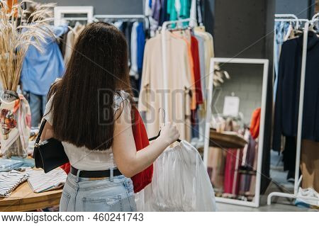 Second Hand. Sustainable Fashion. Young Latina Woman Buying Used Sustainable Clothes From Second Han