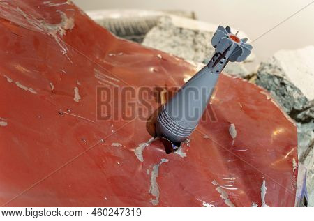 An Unexploded Shell Sticks Out In The Back Of A Car. Close-up