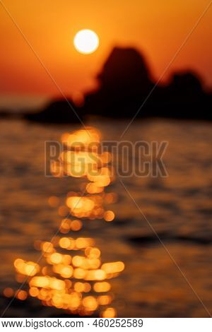 Sunset Sky Reflecting In The Water. Blurry Orange And Golden Skylight Calmness Relaxing Summer Mood.