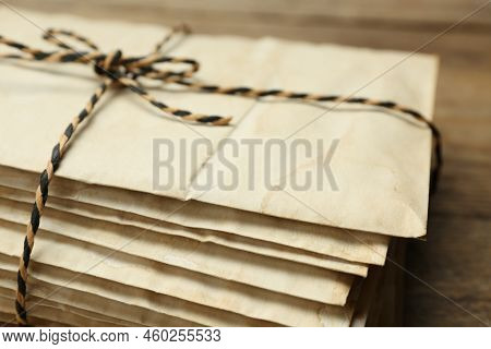 Stack Of Old Letters Tied With String On Wooden Table, Closeup