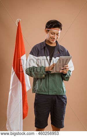 Excited Male Athelete From Indonesia Using Tablet Pc
