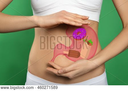Woman With Image Of Stomach Full Of Junk Food Drawn On Her Belly Against Green Background, Closeup. 