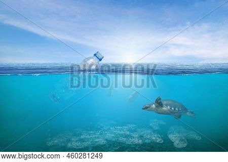 Creative Background, Plastic Bottle Floating In The Ocean, A Bottle In The Water. The Concept Of Env
