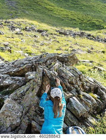 Young Woman Scientist Ecologist Zoologist Setting Up A Trap Camera In A Nature Reserve In The Mounta
