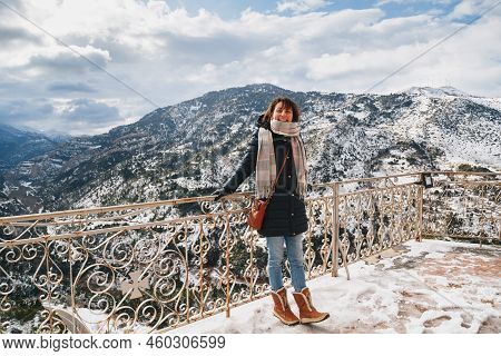 Young Woman Standing At Mountain Top Observation Deck Over Vouraikos Gorge. Mega Spileon Monastery T