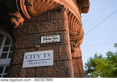 Street Sign On The Wall Of A Decorated Building