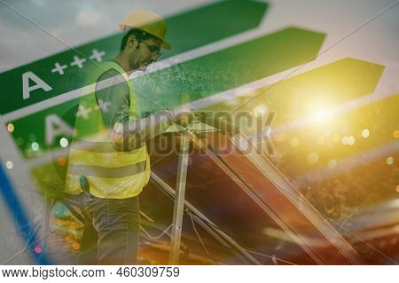 Man Works On Renewable Energy System With Solar Panel For Hot Water