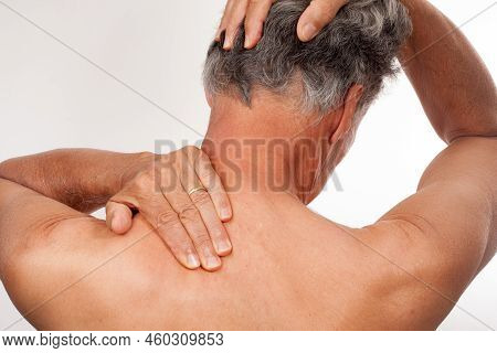 Mature Man 60plus Doing Back Of The Neck Stretches For Back And Neck Pain Relief