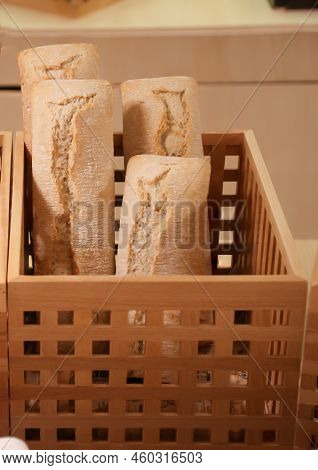 Several Loaves Of Bread, Baguettes Stand On End In The Wooden Basket.
