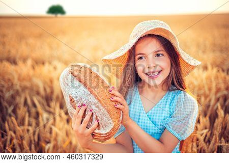 Beautiful Girl, Baker Or Farmer Woman Holding Homemade Baked Bread In Wheat Field. Agriculture And F