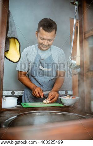 The Seller Slices The Toppings While Preparing The Dish