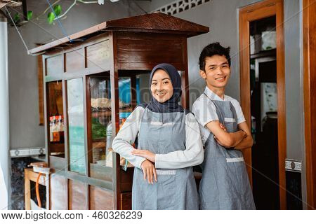 Veiled Woman And Young Man With Crossed Arms Smiling