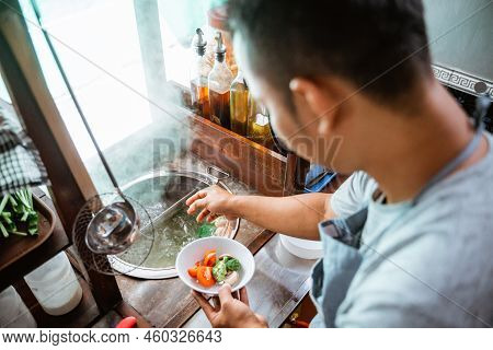 Close Up Of The Seller Prepares The Vegetables