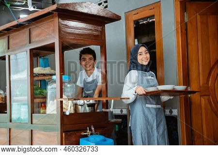 Muslim Sellers In Apron Preparing Chicken Noodles Dish With Bowls