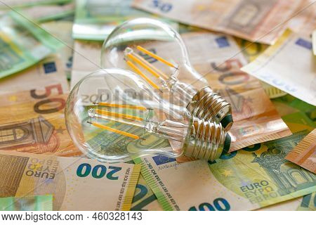 Light Bulbs On Euro Bills.electricity Cost.rising Electricity Prices In Europe. Crisis Of Energy Pro