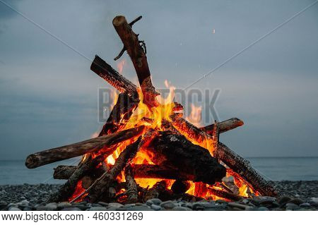 A Bonfire On The Beach. A Bonfire On A Stone Beach. Fire On The Beach - Selective Focus, Copy Space.