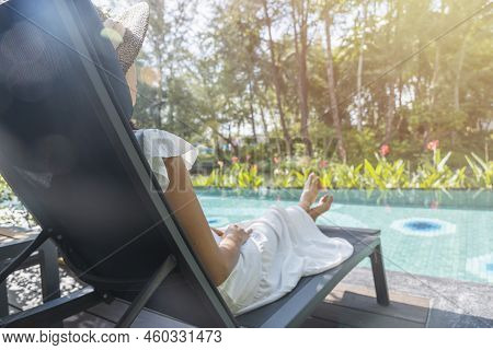 Portrait Beautiful Traveler Asian Woman In White Dress And Straw Hat Relaxing On Chair Beach By The